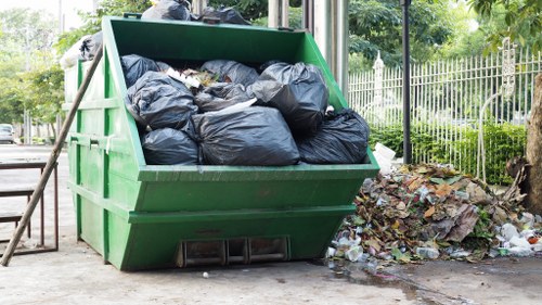 Workers loading a van for rubbish removal during an office clearance