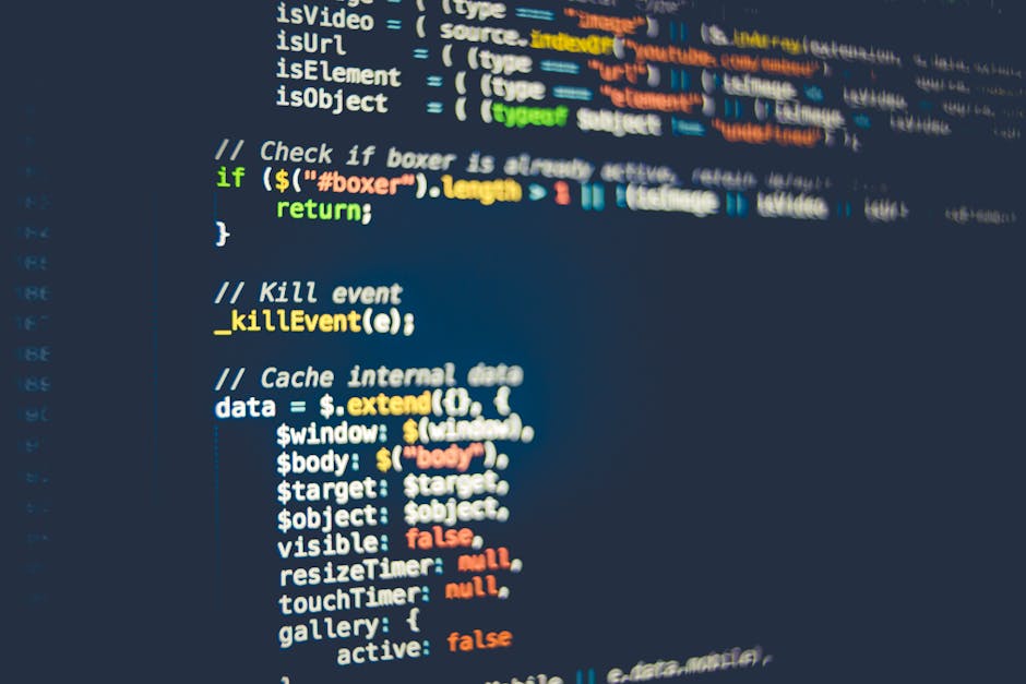 A close-up digital photograph of a computer screen displaying lines of source code with syntax highlighting in various colors such as green, yellow, and white. The code consists of HTML elements inclu